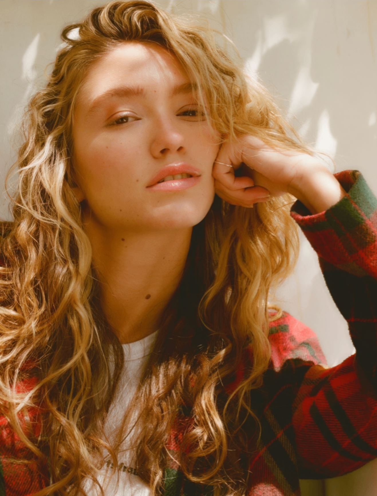 Natural curly blonde hair with defined spiral curls and sunlit dimensional highlights by Heidi Stanton, curly hair specialist Los Angeles